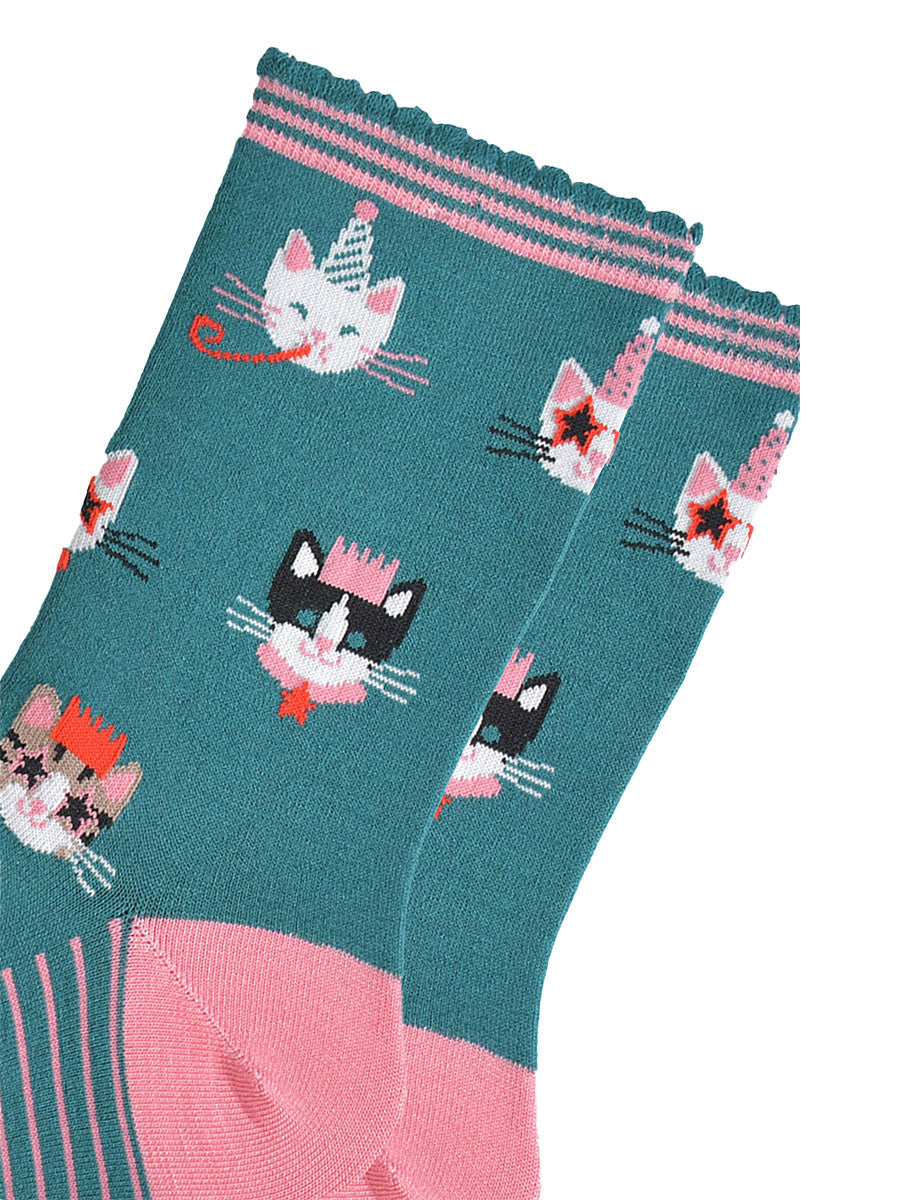 close up of the cat design on the socks, there is a white cat wearing a party hat and blowing a party trumpet, a white cat with a party hat wearing star shaped sunglasses, a black and white cat wearing a pink party crown and a tabby cat wearing a party crown and glasses.