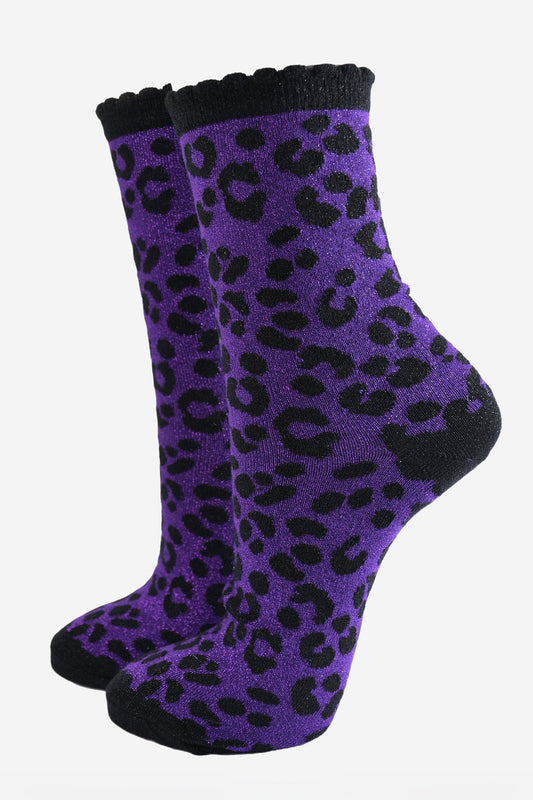 purple ankle socks with a black leopard print pattern, all over glitter sparkle and black scalloped cuff