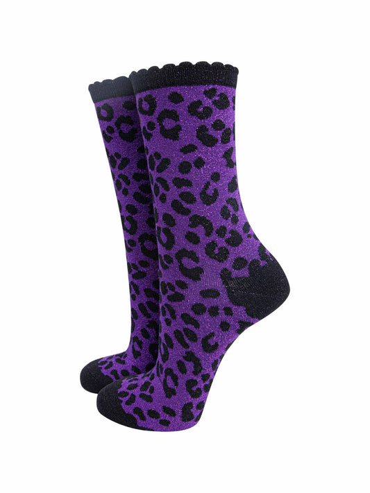 purple ankle socks with a black leopard print pattern, all over glitter sparkle and black scalloped cuff