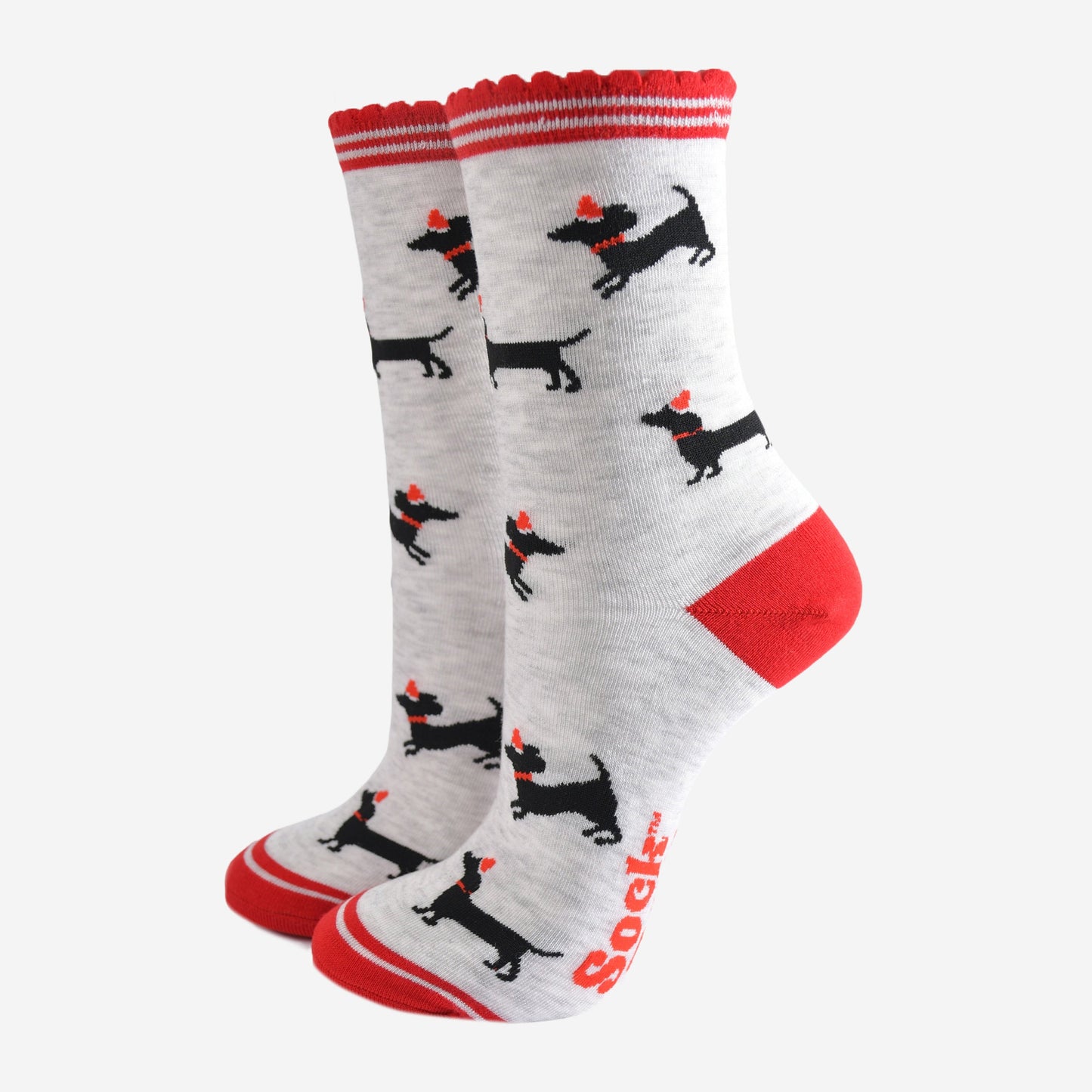 light grey socks with red heel, toe and scalloped cuff with an all over pattern of black sausage dog silhouettes wearing red santa party hats