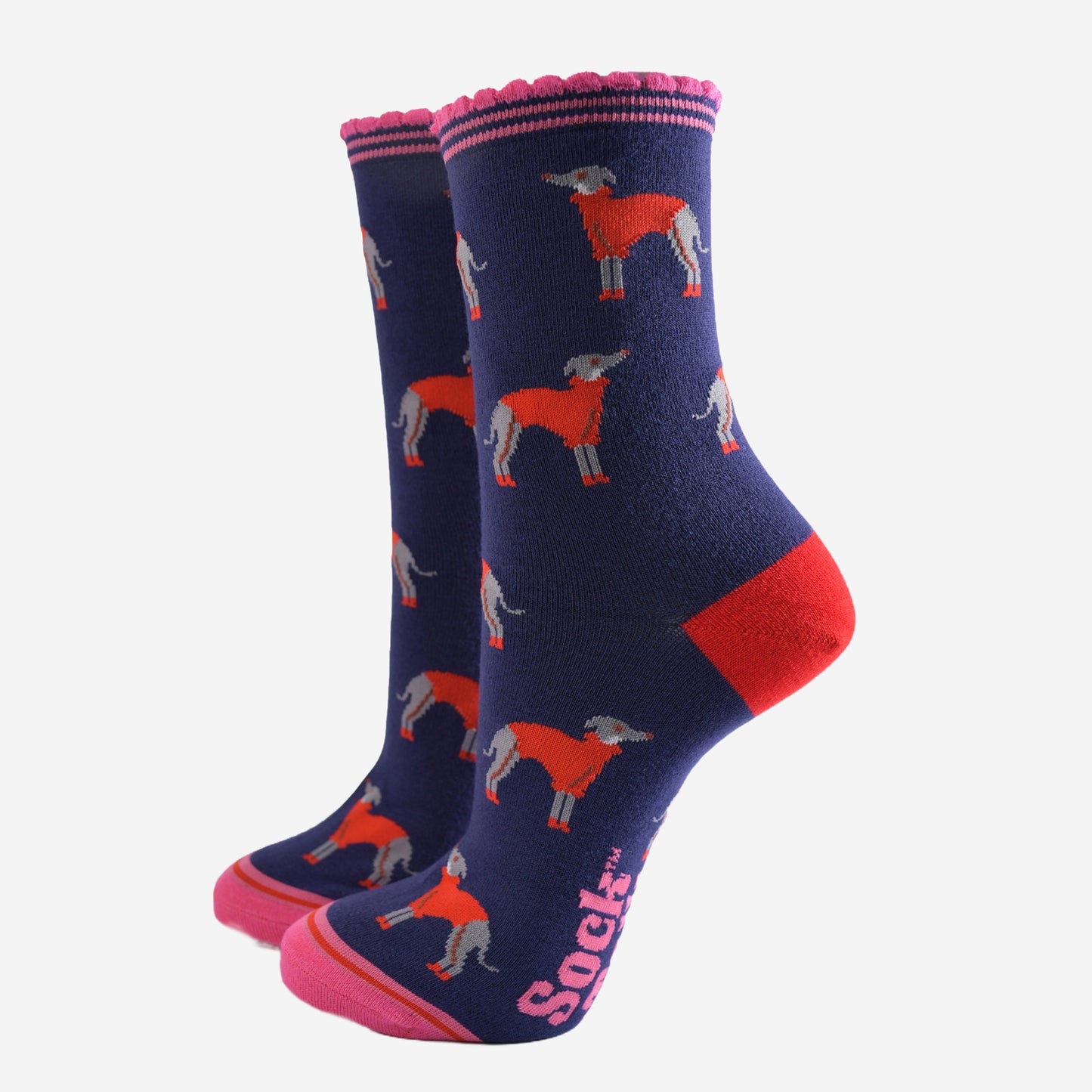 navy blue ankle socks with a pink scalloped cuff, with a pattern of greyhound dogs wearing cosy red knitted jumpers