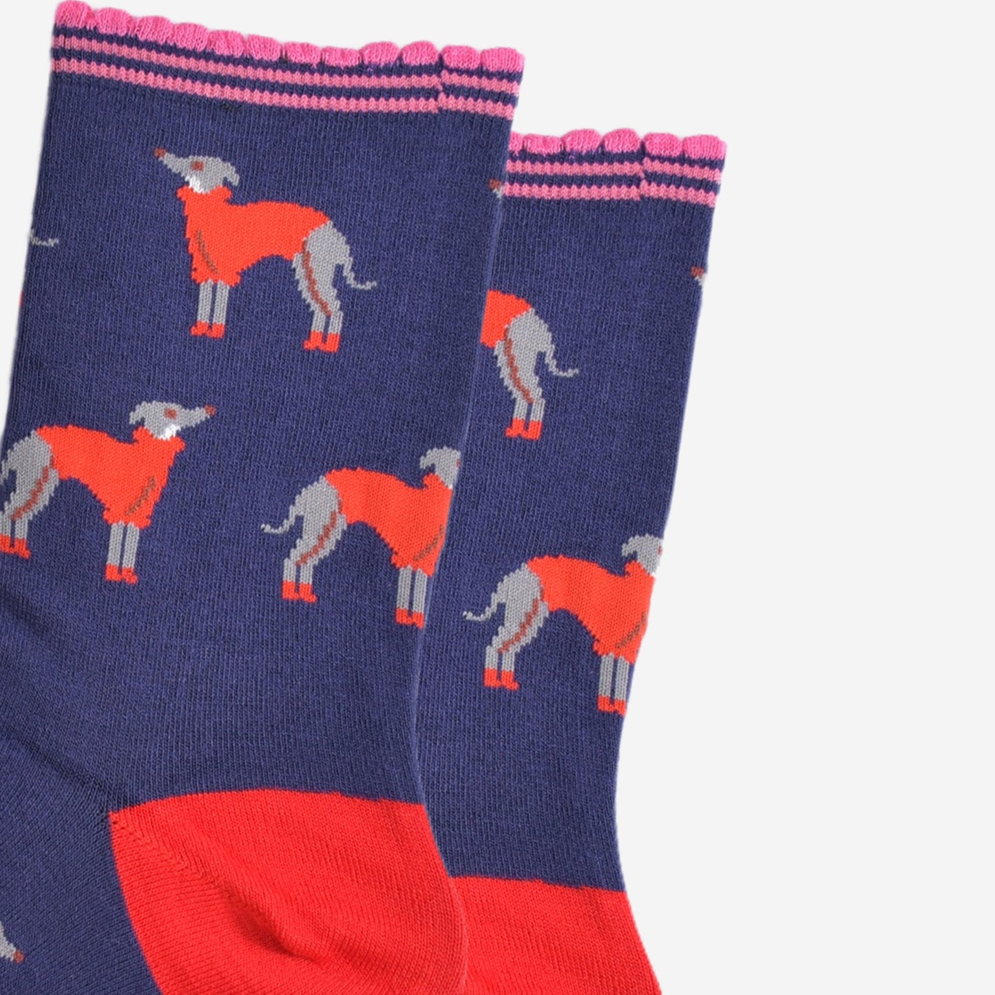 close up of the greyhound pattern on the socks, the grey hounds are grey with white necks, they are wearing red winter coats and red booties