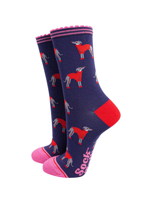 navy blue ankle socks with a pink scalloped cuff, with a pattern of greyhound dogs wearing cosy red knitted jumpers