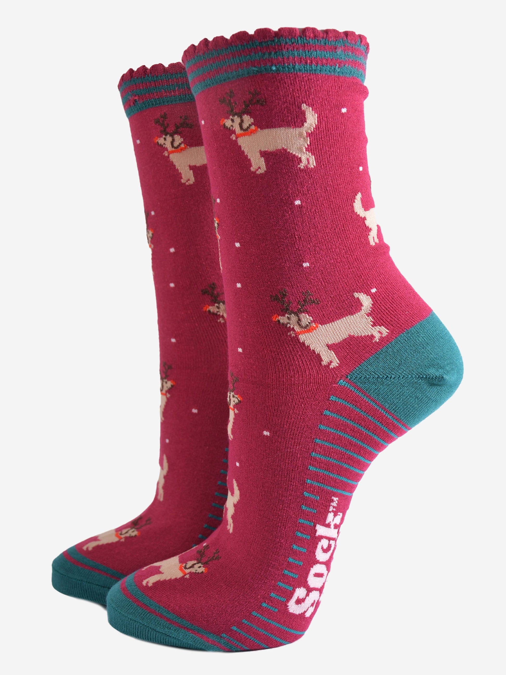 berry red socks with a pattern of golden retriever dogs wearing xmas reindeer antlers