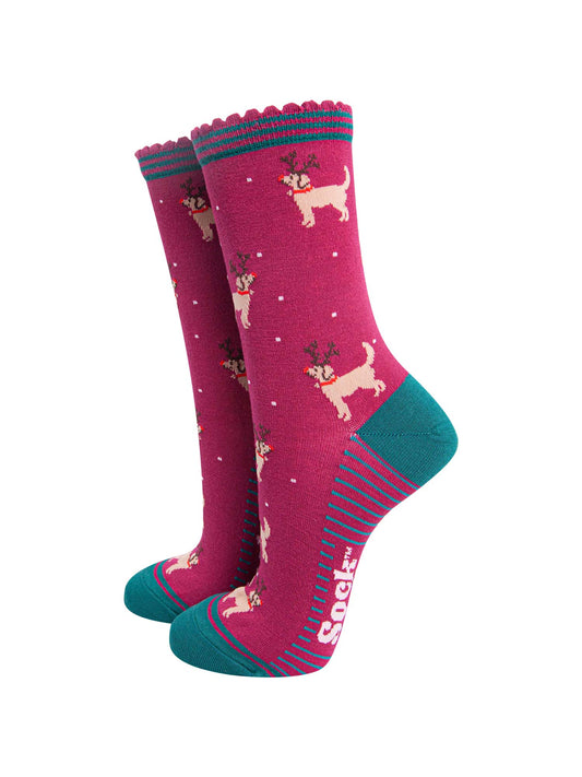 berry red socks with a pattern of golden retriever dogs wearing xmas reindeer antlers