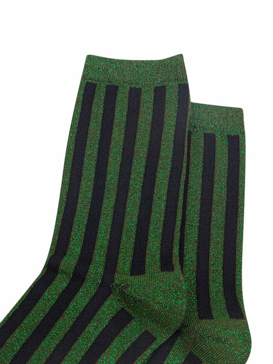close up of the khaki green and black vertical striped pattern on the socks. there is an all over silver glitter sparkle