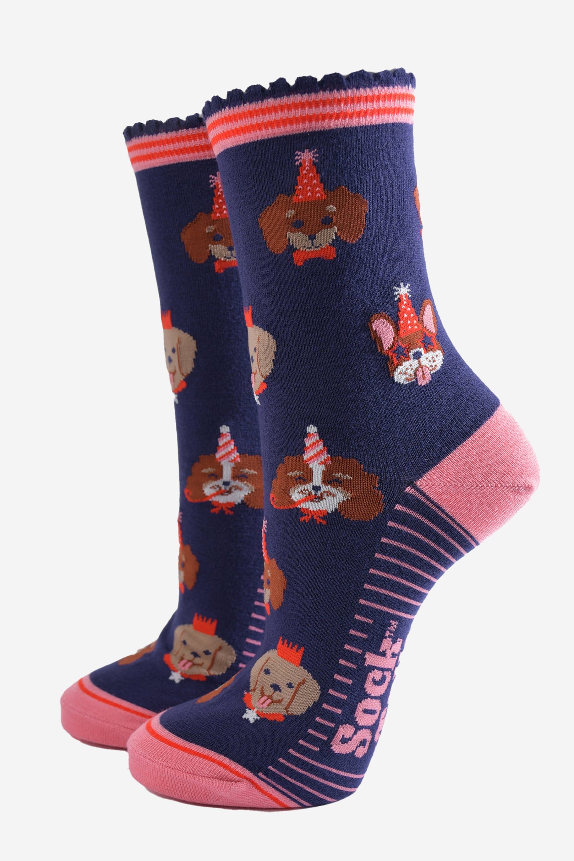 navy blue and pink ankle socks with a pattern of dogs wearing party hats and novelty glasses