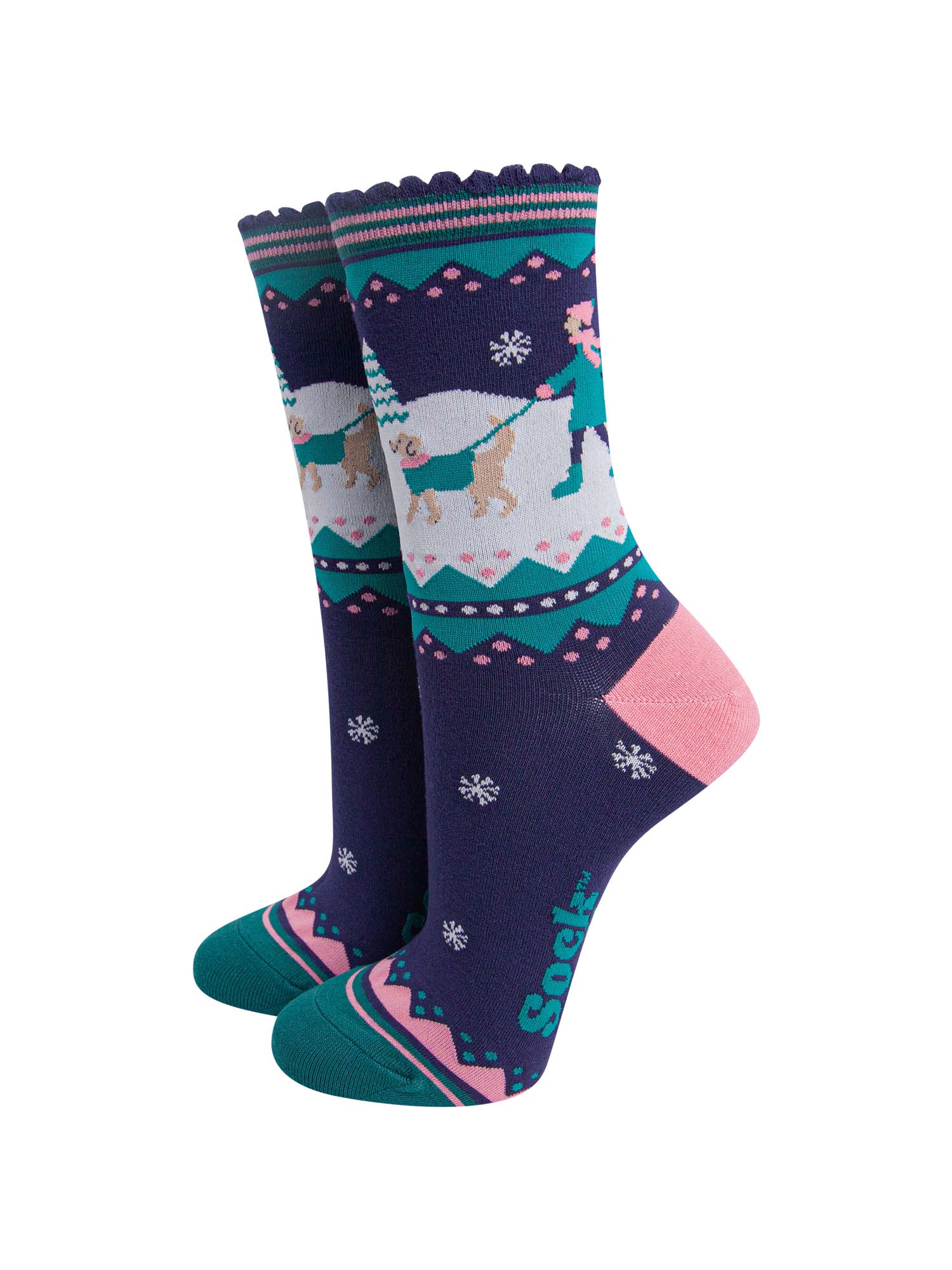 navy blue, pink and teal ankle socks featuring a snowy winter scene with a golden retriever dog taking its owner for a walk