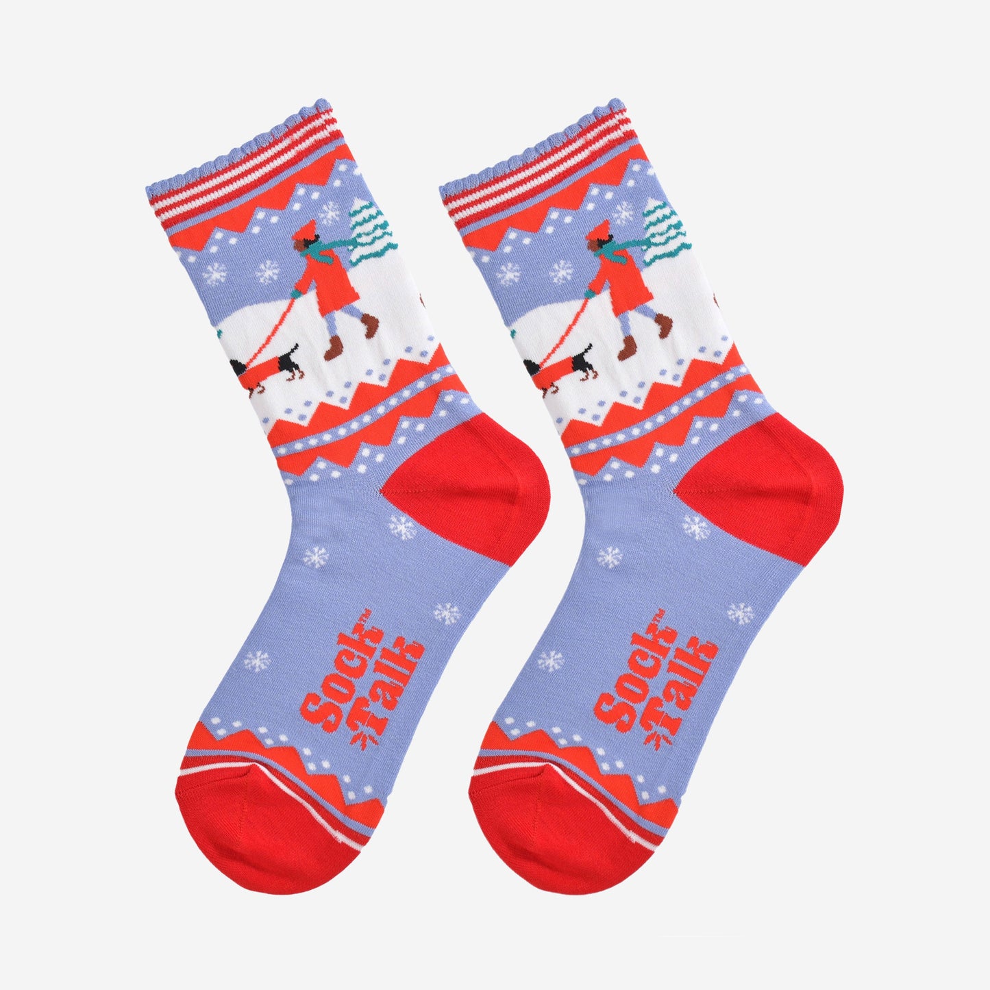 showing the sausage dog socks laying flat, there is a pattern of white snowflakes throughout the design, on the ankle of the socks the sausage dog design is prominent