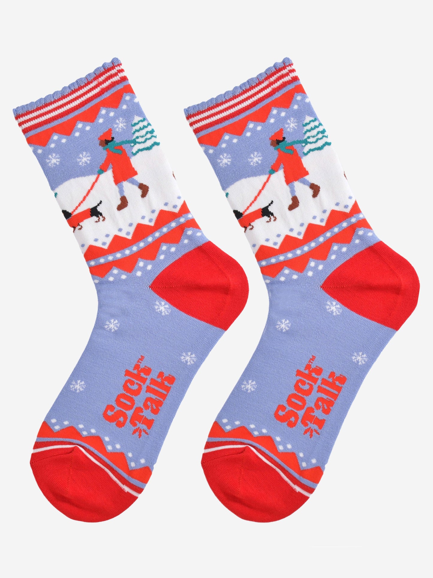 showing the sausage dog socks laying flat, there is a pattern of white snowflakes throughout the design, on the ankle of the socks the sausage dog design is prominent