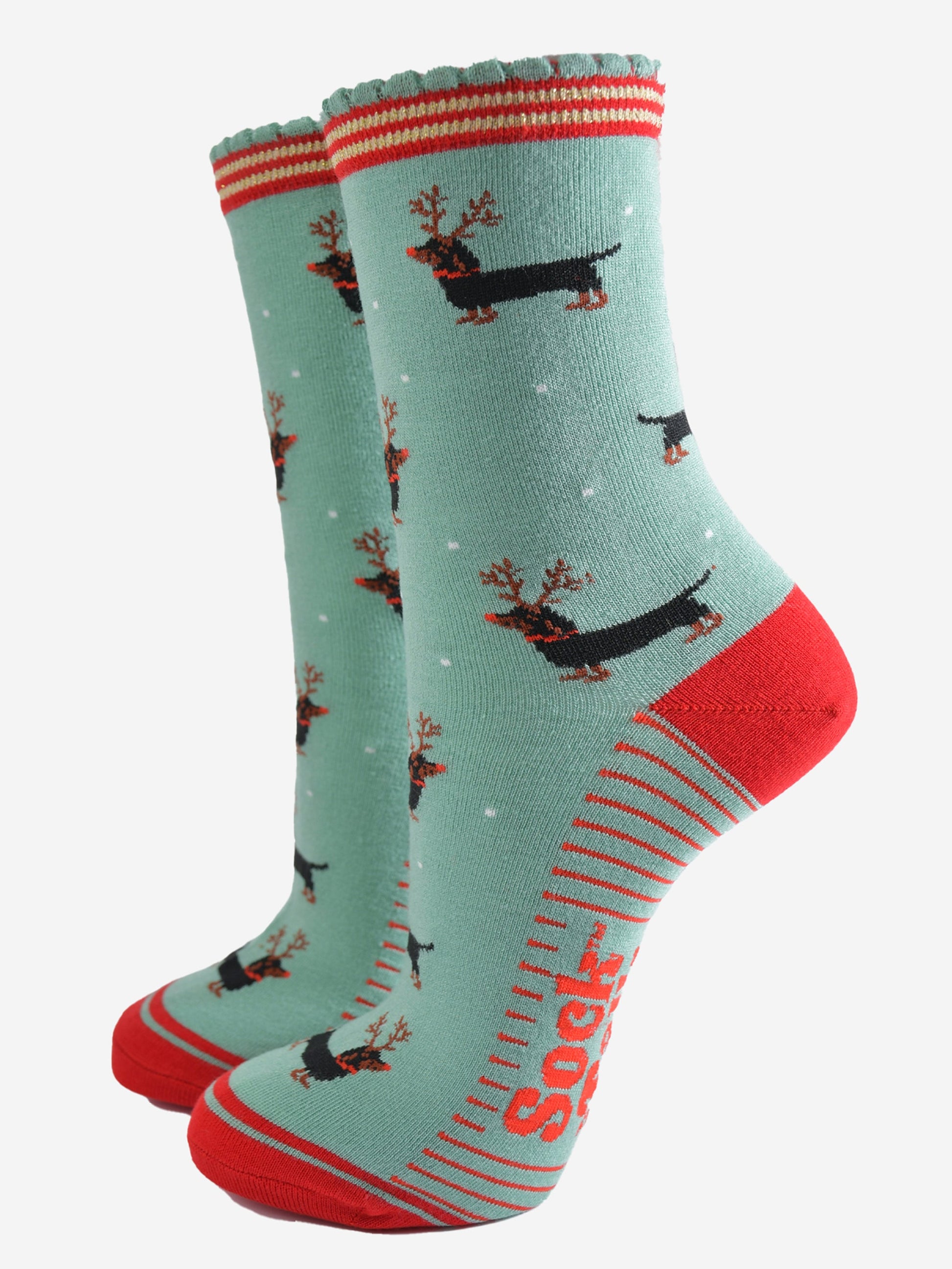 green and red ankle socks with a scalloped cuff and a pattern of dachshund dogs wearing reindeer antlers