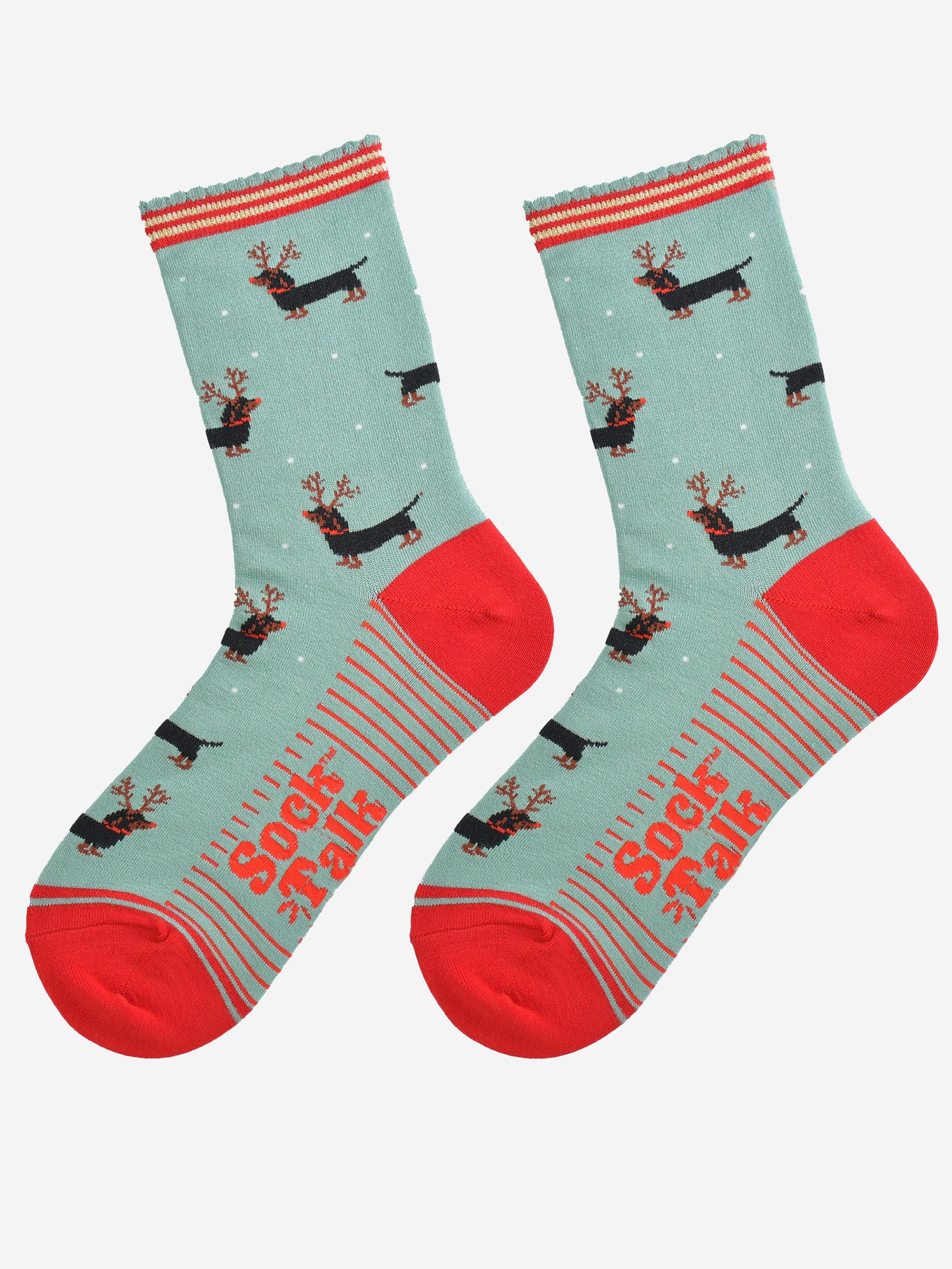 showing the sausage dog reindeer socks laying flat, the soles have red stripes and the dachshund dog pattern is shown to repeat all over the design.