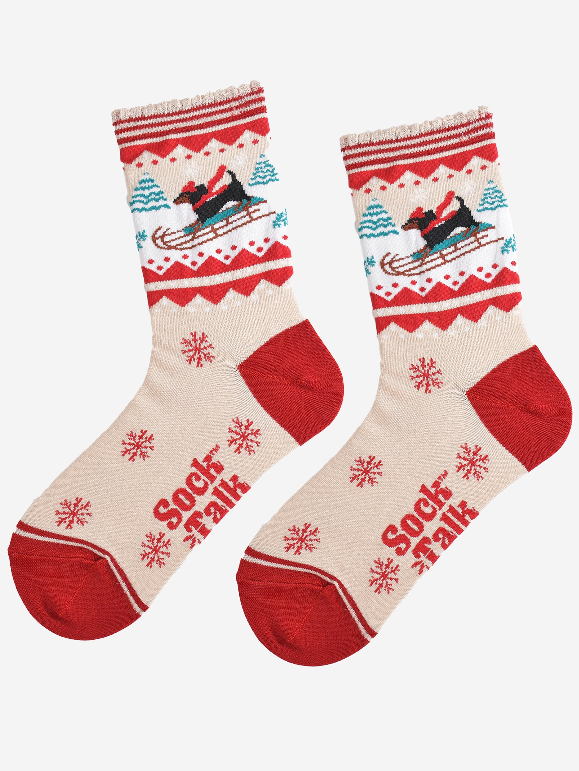 showing the sledging sausage dog socks laying flat, there is a pattern of large red snowflakes on the cream base of the socks