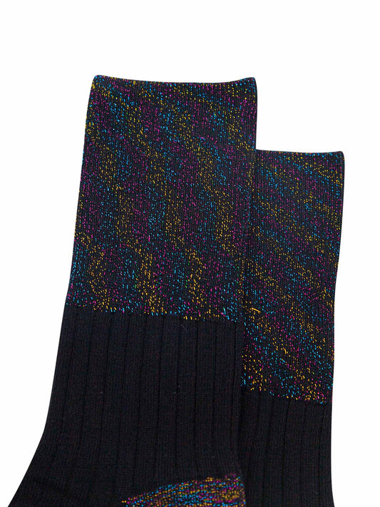 close up of the black rainbow glitter folding cuff on the black cotton socks. showing an all over rainbow sparkle