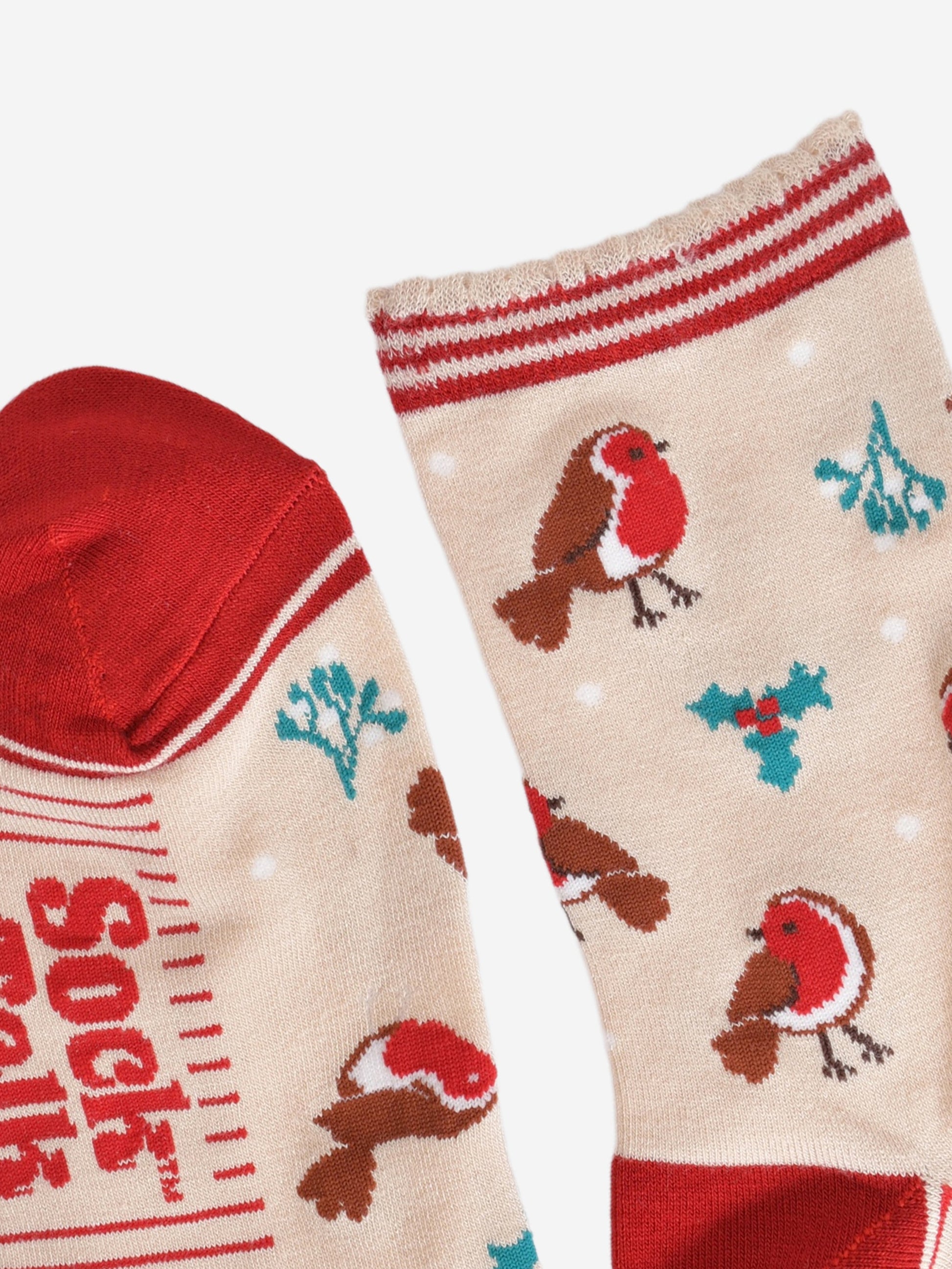 close up of the toe and cuff, the toe is red in contrast to the cream colour of the socks, the cuff is scalloped with three red horizontal stripes around the edges