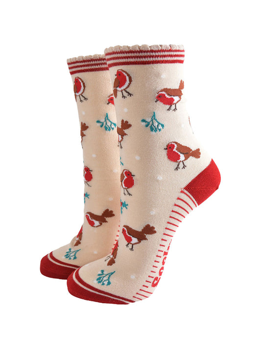 cream socks with a red striped cuff with a pattern of red robin birds, mistletoe and holly all over