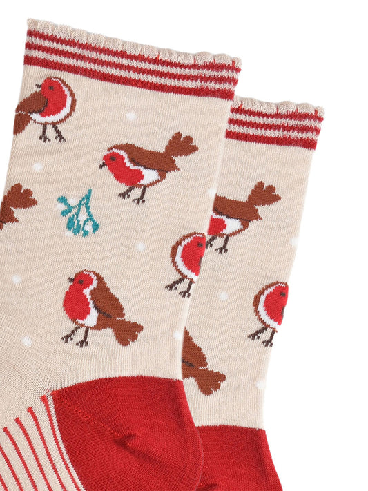 close up of the red robins and mistle toe pattern on the socks, also visible are small white dots designed to look like subtle falling snowflakes