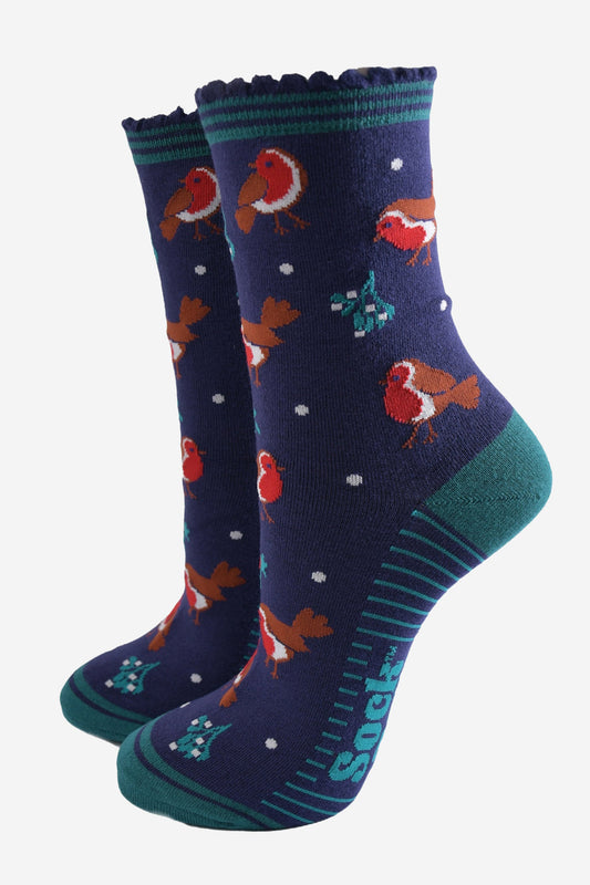 navy blue socks with a green striped cuff with a pattern of red robin birds, mistletoe and holly all over