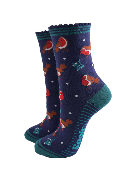navy blue socks with a green striped cuff with a pattern of red robin birds, mistletoe and holly all over