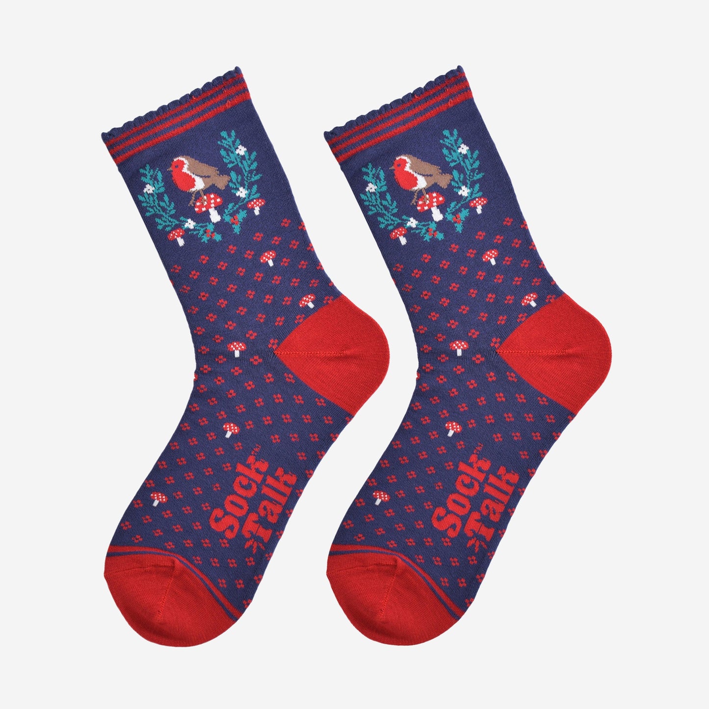 navy blue and red robin christmas socks laying flat, showing the all over floral pattern and the robin and holly motif on the ankle of the socks