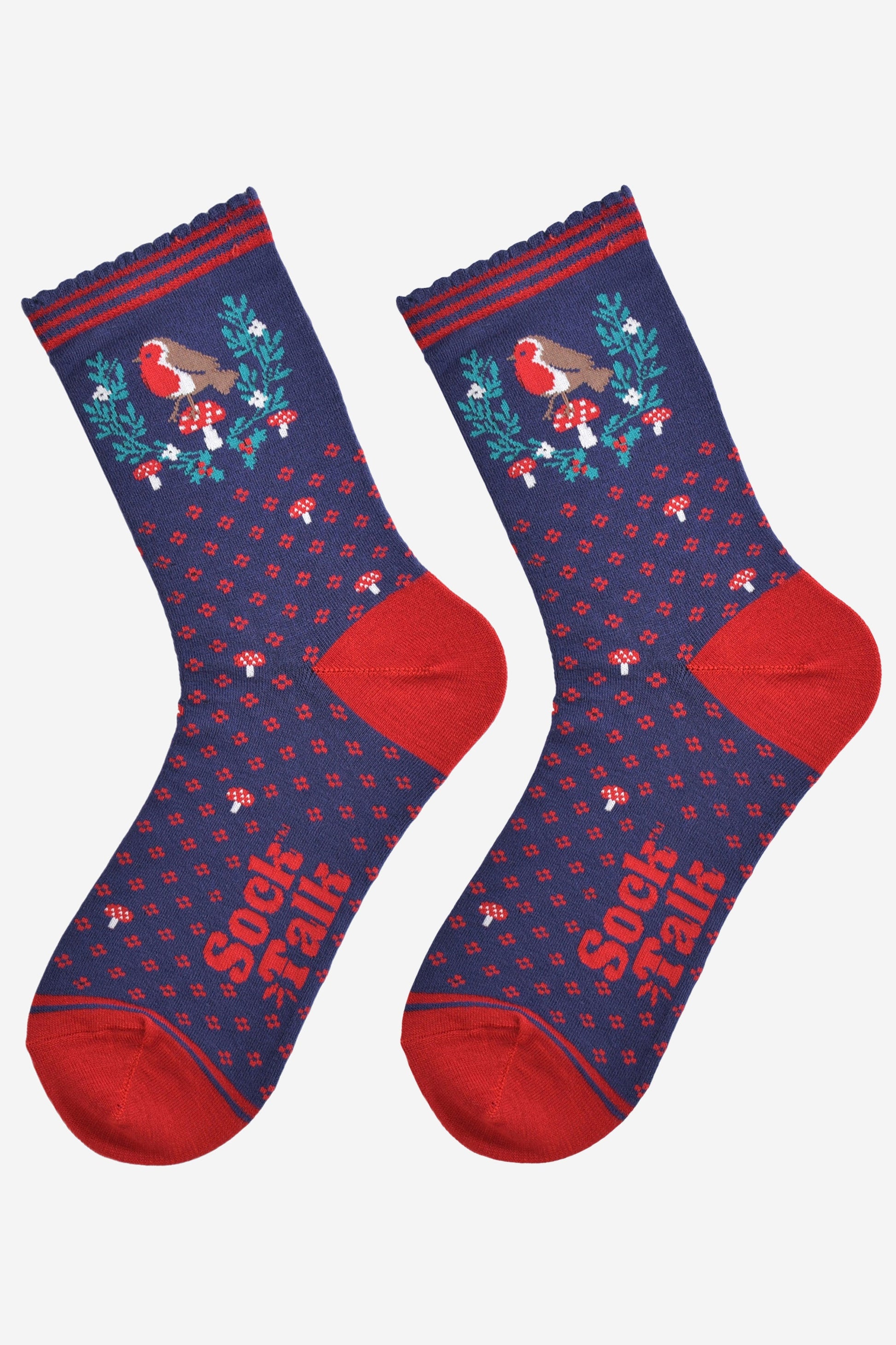 navy blue and red robin christmas socks laying flat, showing the all over floral pattern and the robin and holly motif on the ankle of the socks