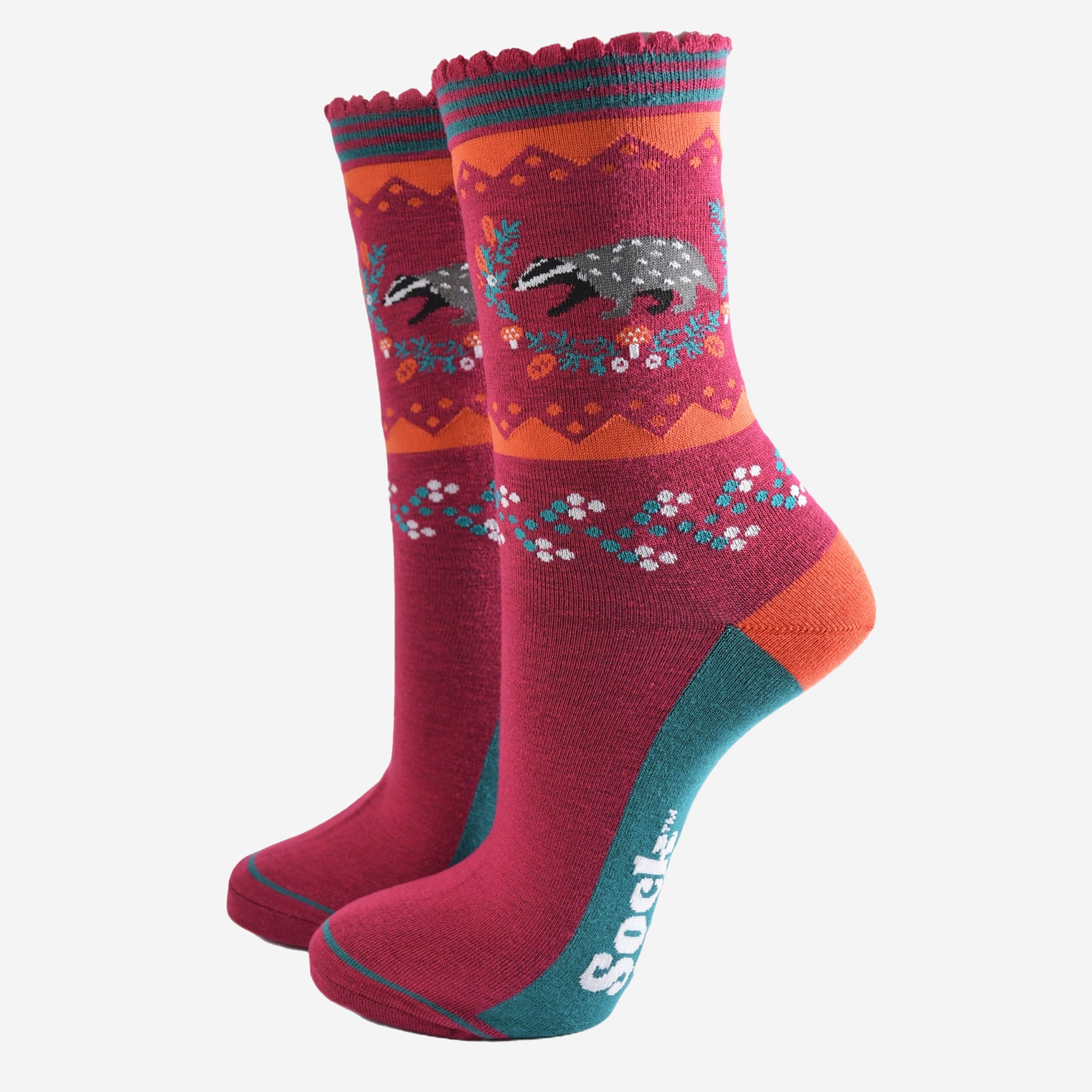 berry red socks with a woodland badger and autumnal floral wreath motif on the ankle