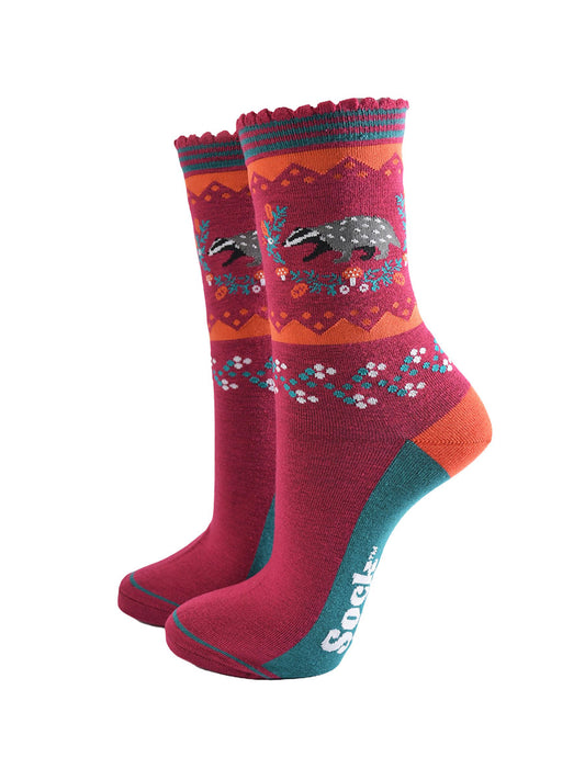 berry red socks with a woodland badger and autumnal floral wreath motif on the ankle
