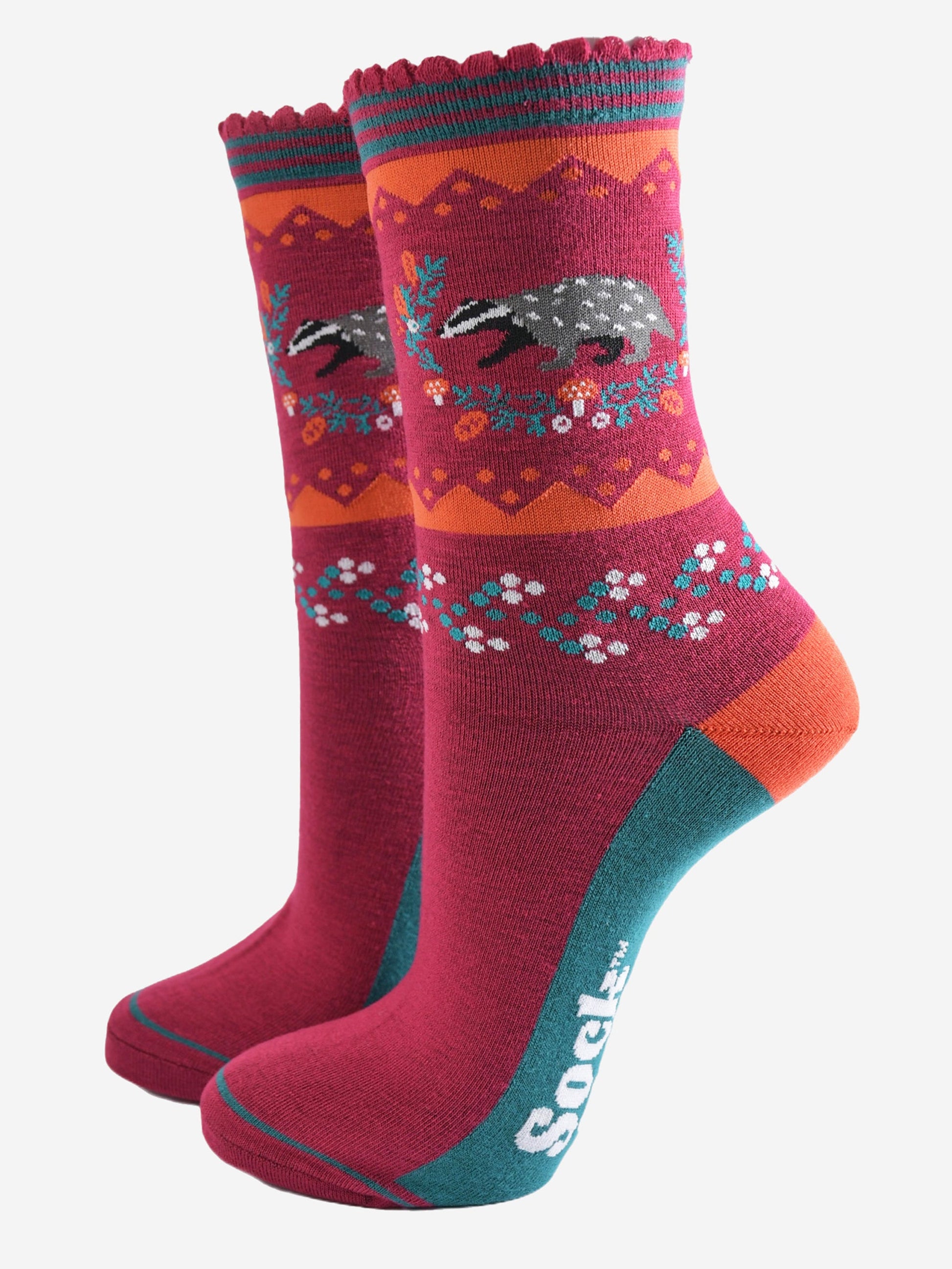 berry red socks with a woodland badger and autumnal floral wreath motif on the ankle