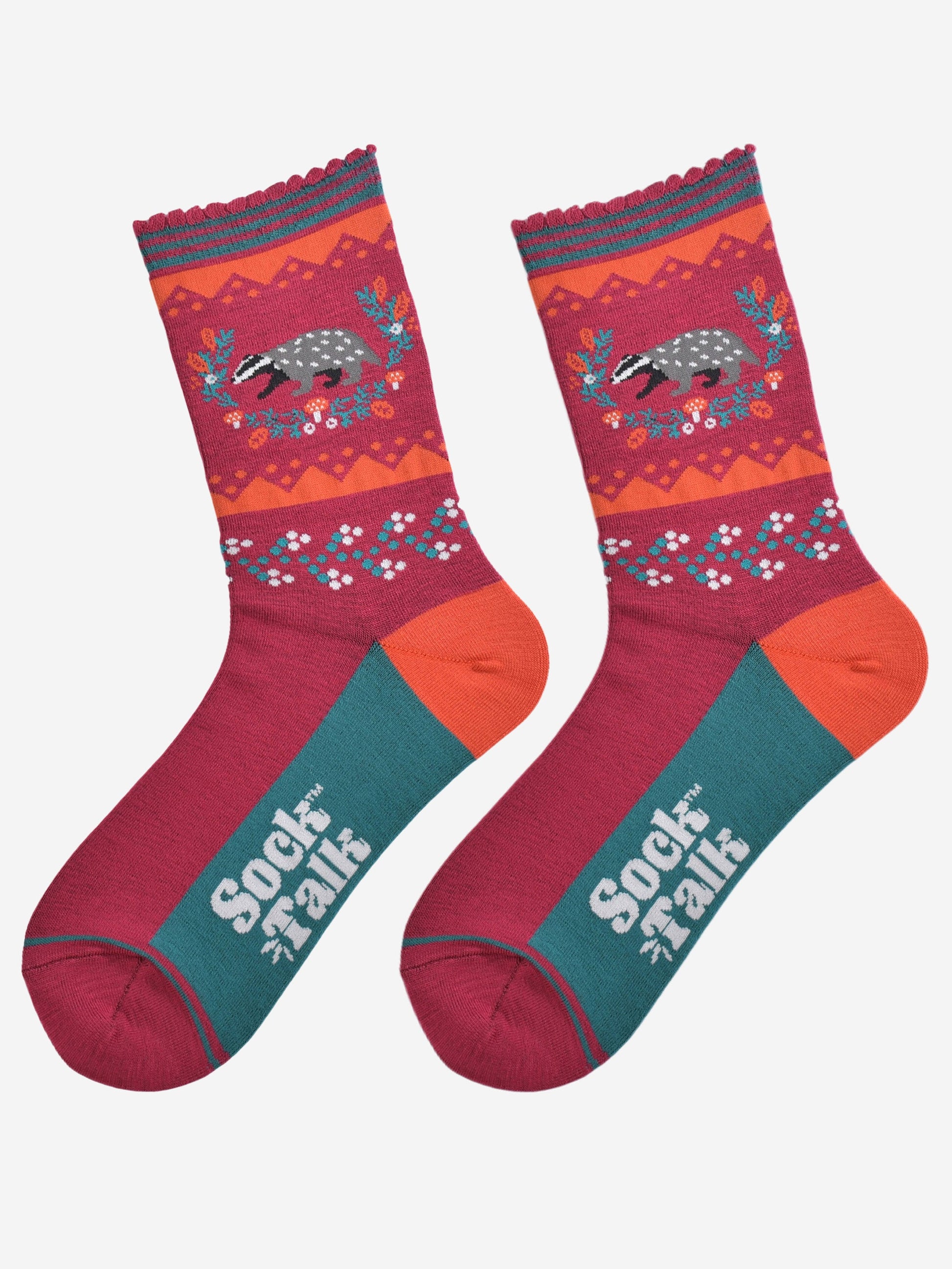 showing the badger wreath socks laying flat, the sole is green in contrast to the top of the socks, the badger on the ankle is surrounded by an autumnal foliage wreath