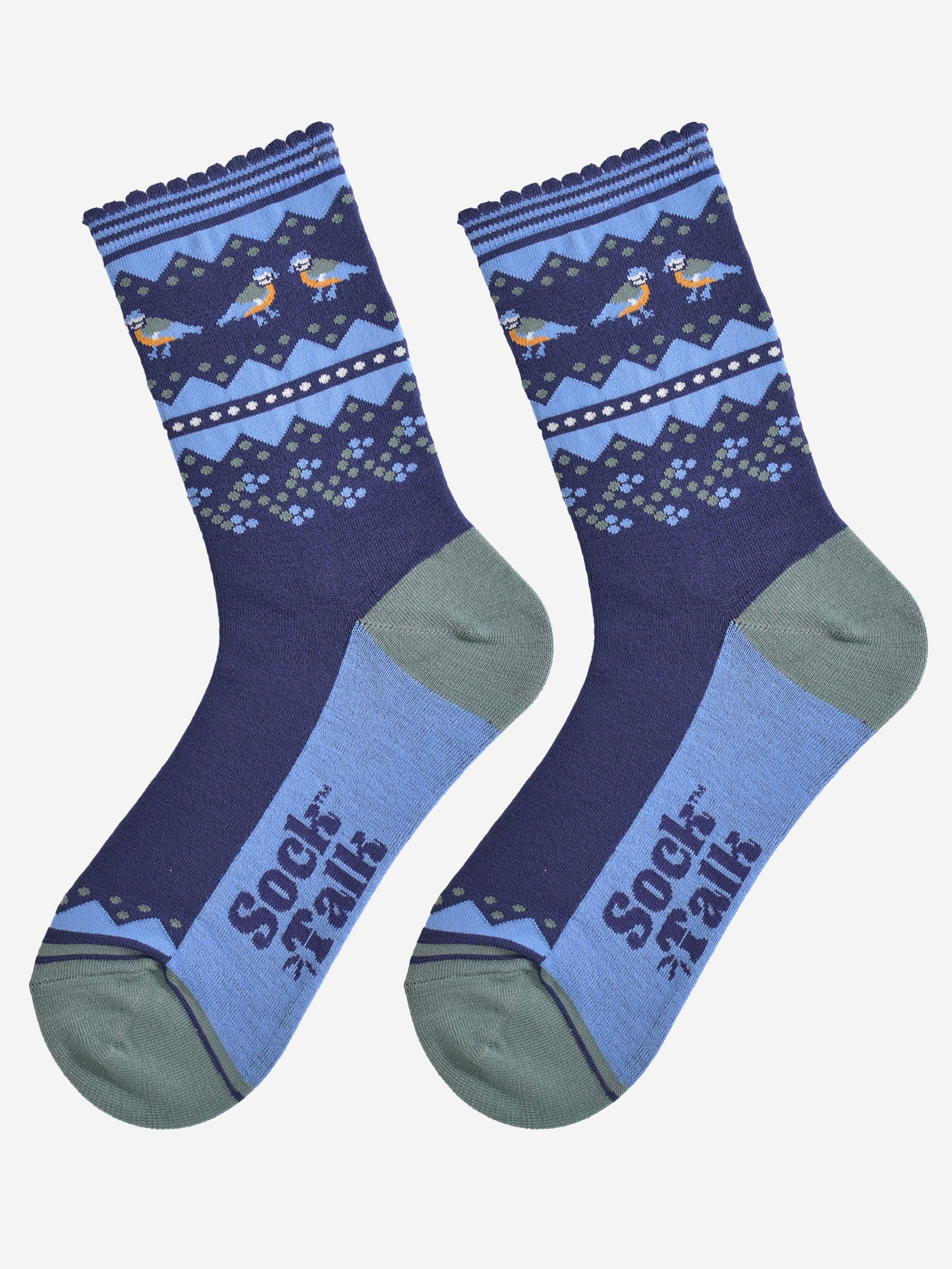 blue tit fair isle socks laying flat, showing the contrasting dark and light blue socks, with a decorative fair isle pattern around the ankles featuring blue tit garden birds