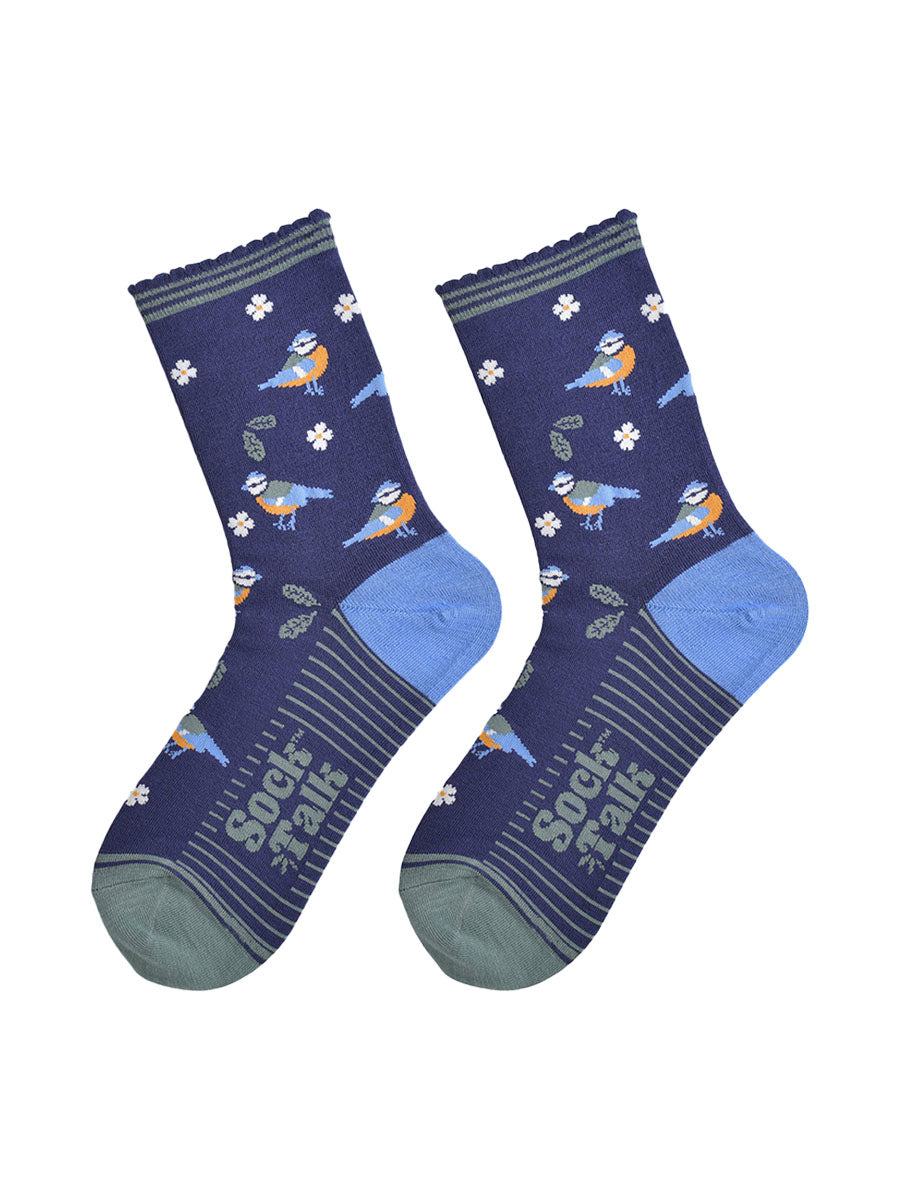 blue tit woodland bamboo socks laying flat, showing the all over pattern of birds, leaves and flowers on a navy blue background