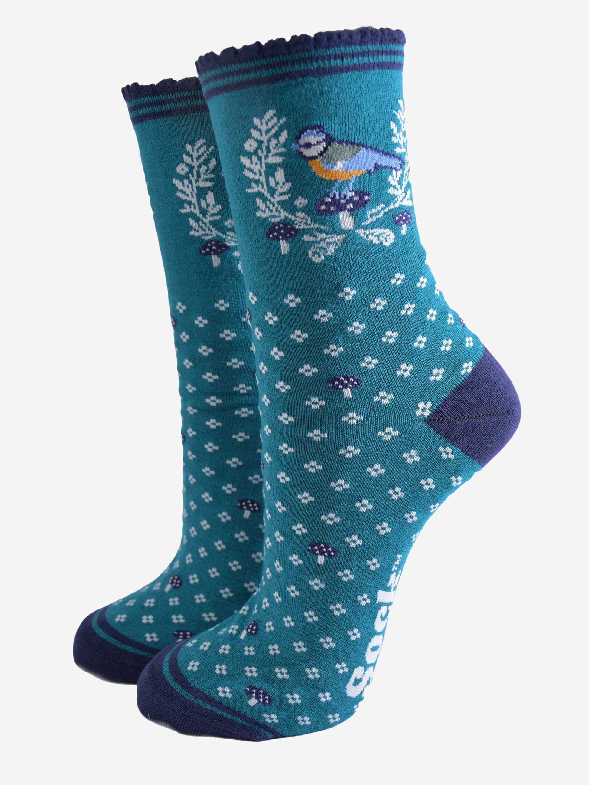 teal blue ankle socks with a navy scalloped cuff with a pattern of blue tit birds, floral wreath and blue toadstools