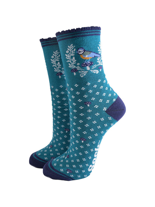 teal blue ankle socks with a navy scalloped cuff with a pattern of blue tit birds, floral wreath and blue toadstools