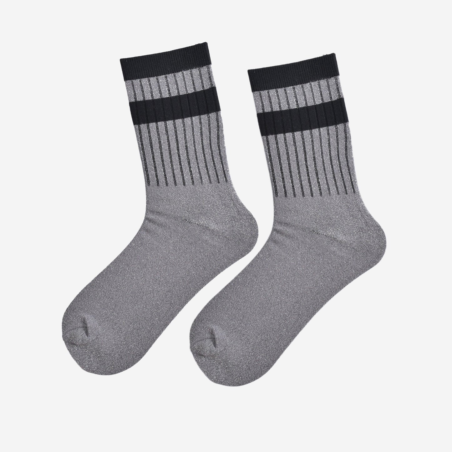 showing the socks laying flat, they have an all over silver glitter sparkle, ribbed cuffs and black striped bands on the cuff and ankle