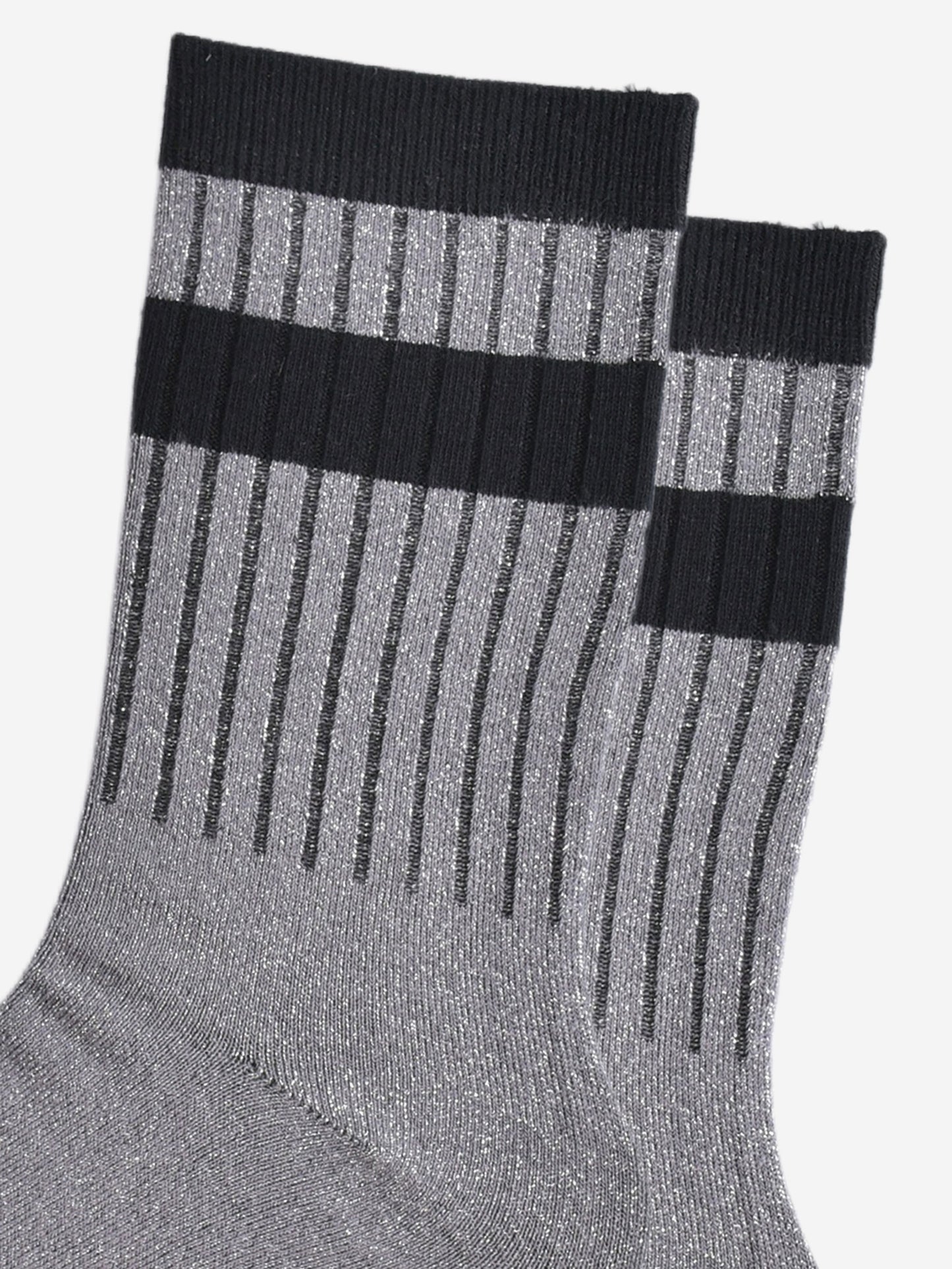 close up of the ribbed sports style cuffs on the socks. they have vertical ribbed details. the base of the socks are grey with a silver glitter sparkle. the cuff is black and there is a horizontal black band stripe, without glitter an inch below the cuff. 