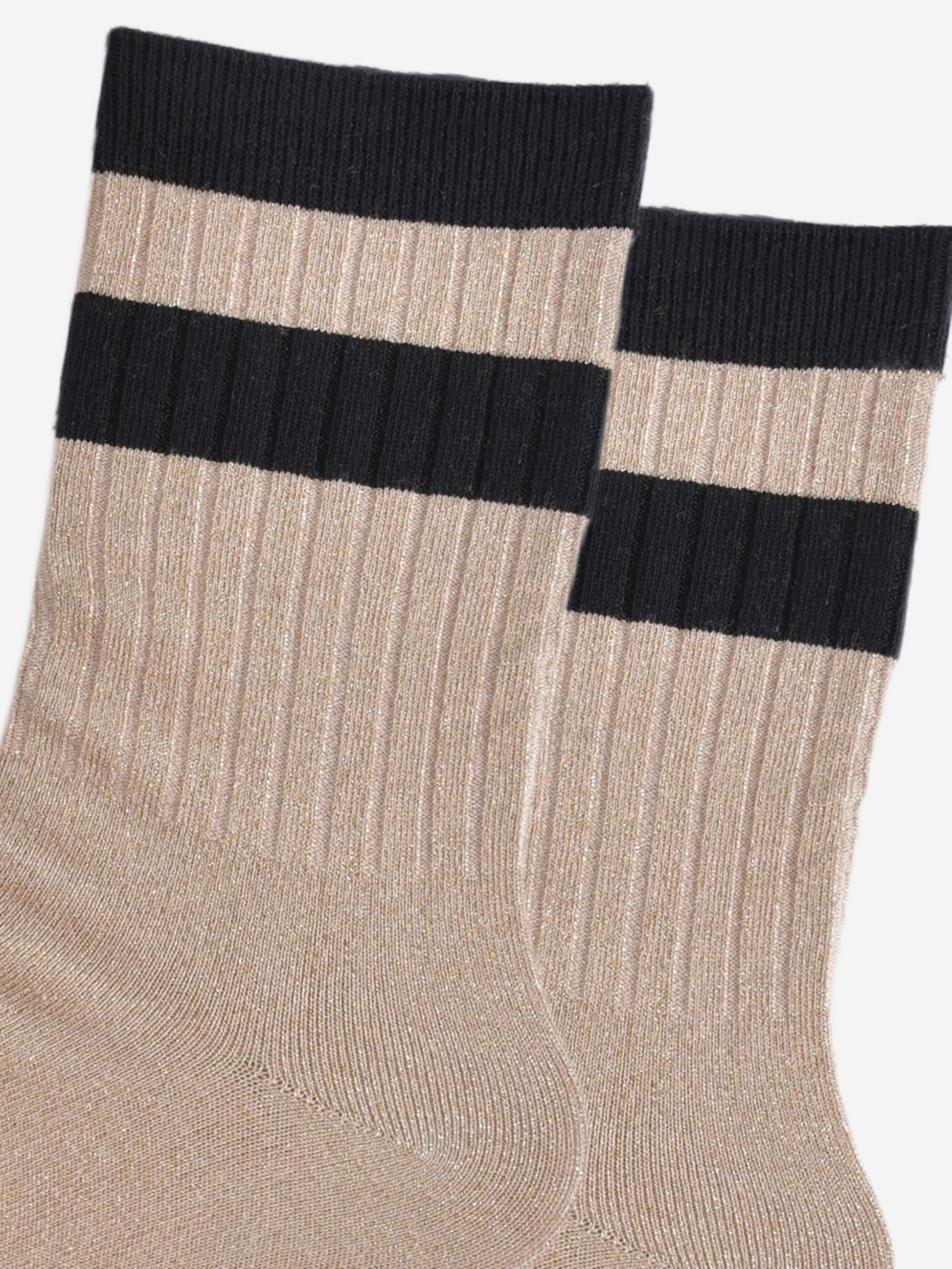 close up of the ribbed sports style cuffs on the socks. they have vertical ribbed details. the base of the socks are gold with a glitter sparkle. the cuff is black and there is a horizontal black band stripe, without glitter an inch below the cuff. 