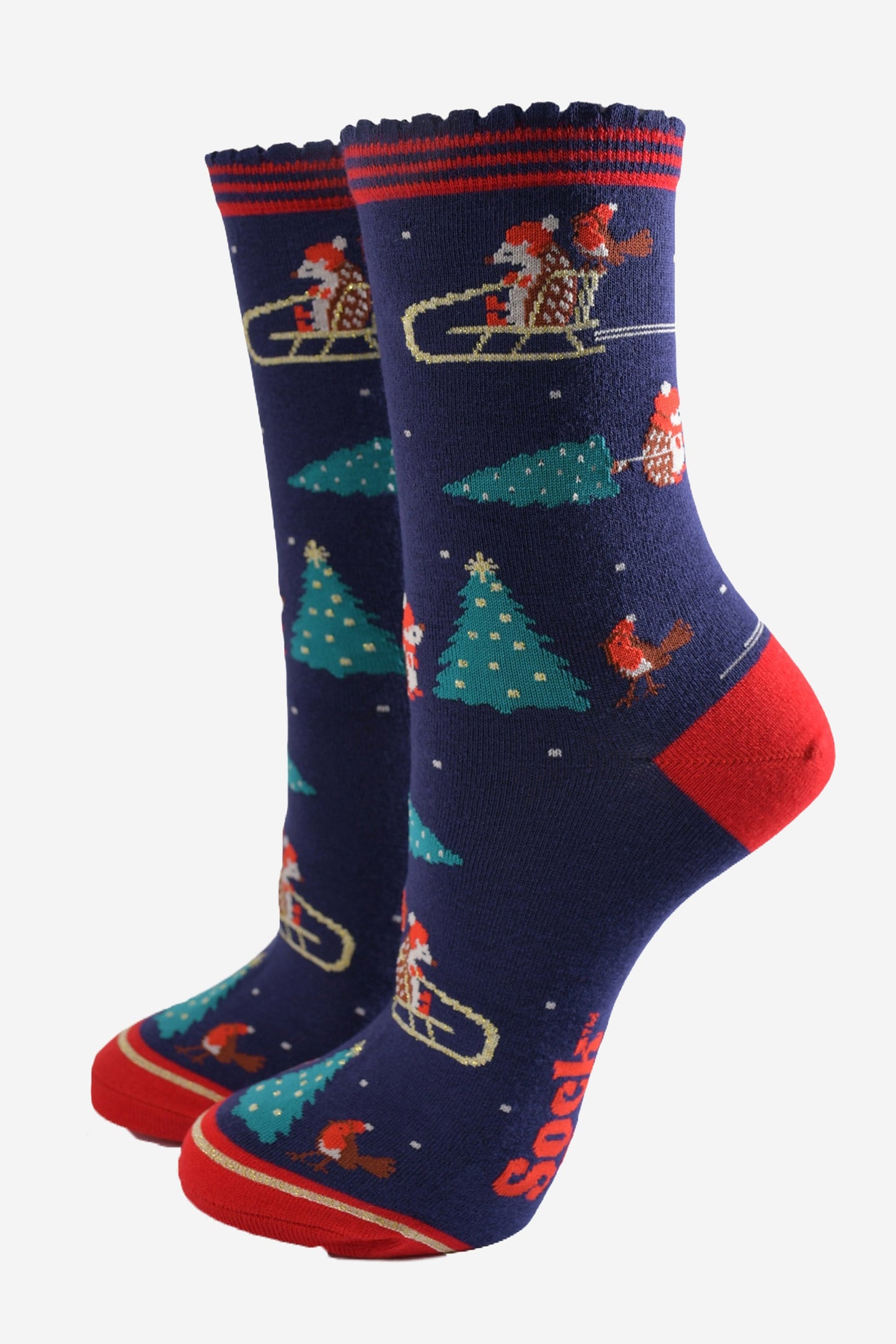 navy blue and red ankle socks featuring a sledging hedgehog, red robins and xmas trees