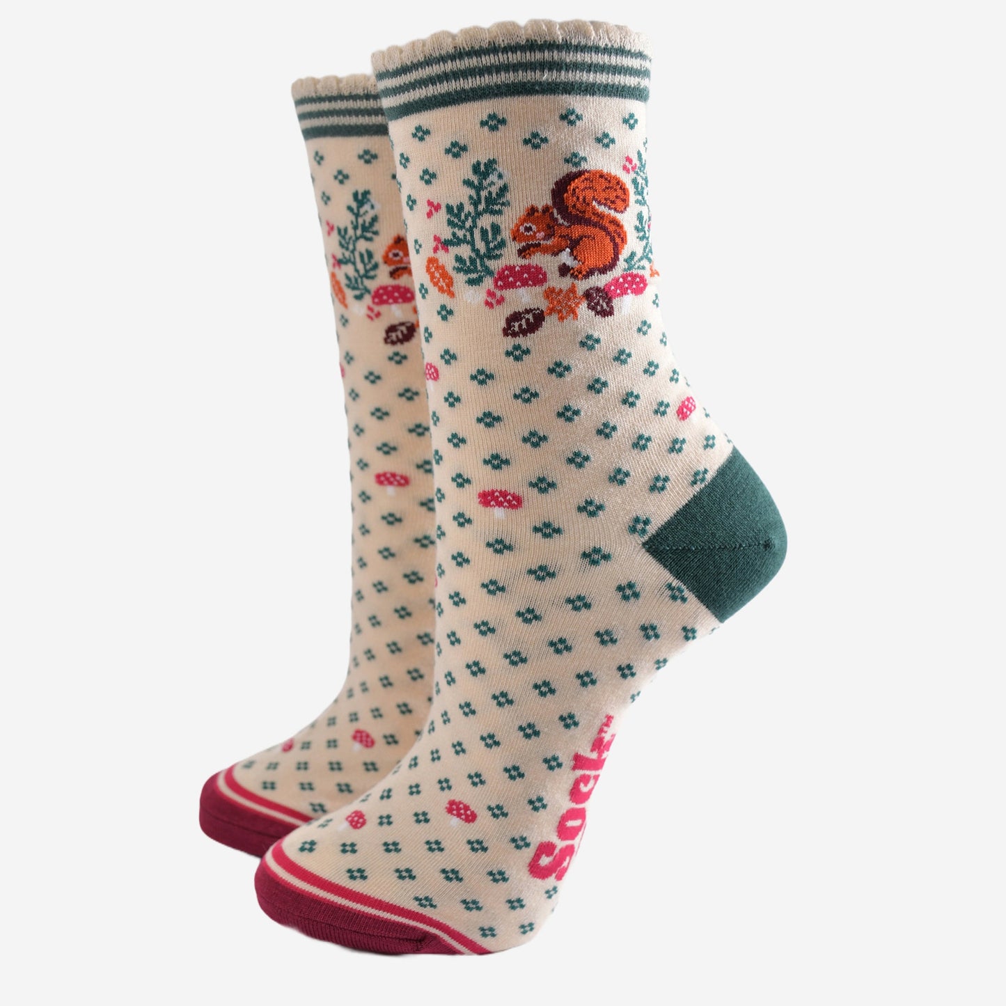 cream socks with a red squirrel, toadstools and autumn leaves on the ankle