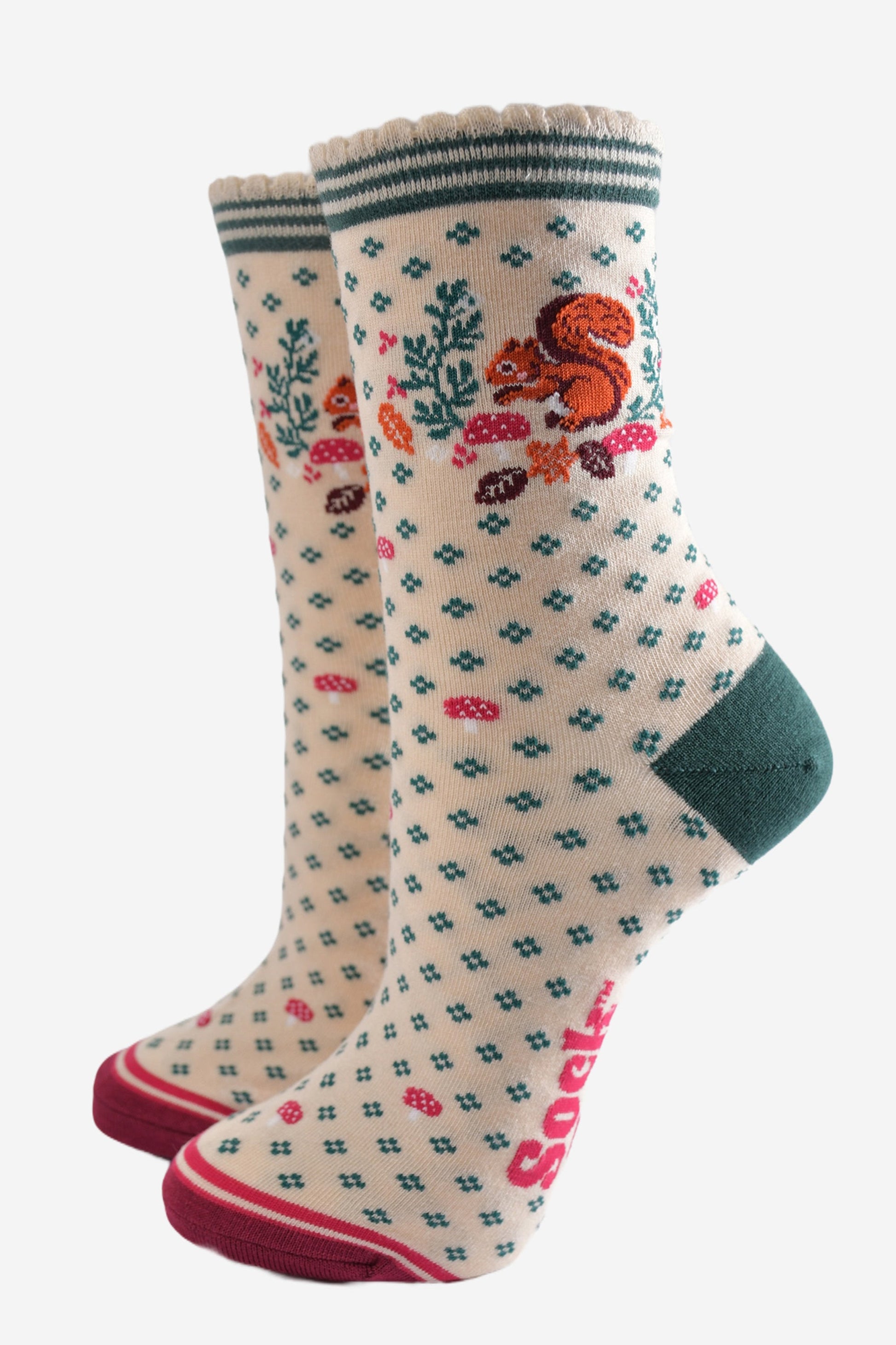 cream socks with a red squirrel, toadstools and autumn leaves on the ankle