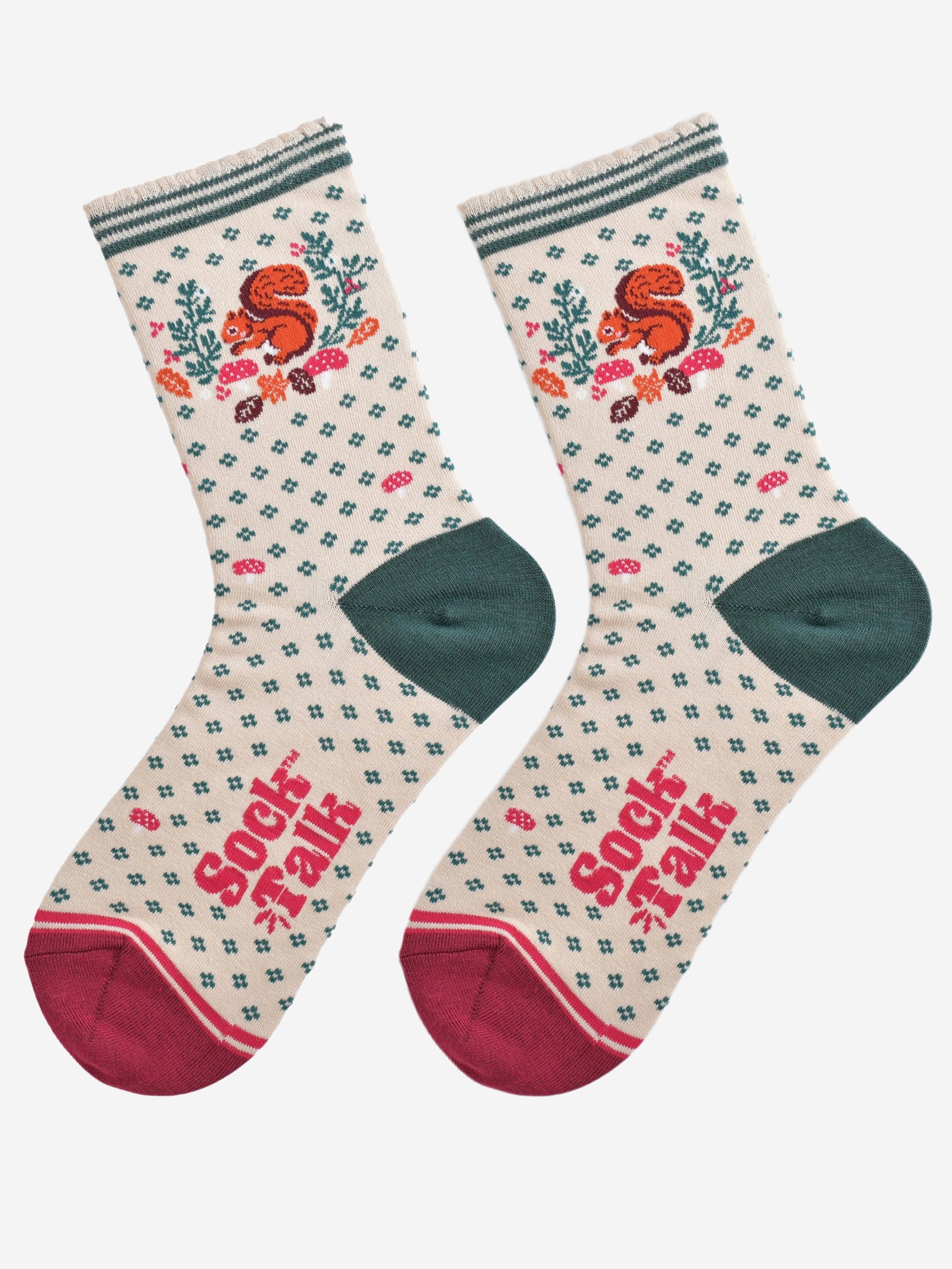 cream and green squirrel wreath socks laying flat, showing the all over green floral pattern and dominant red squirrel and wreath design on the ankle of the socks