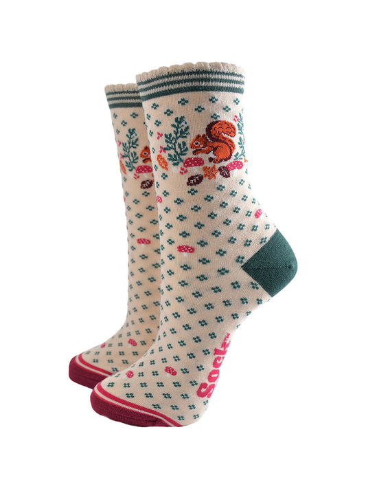 cream socks with a red squirrel, toadstools and autumn leaves on the ankle