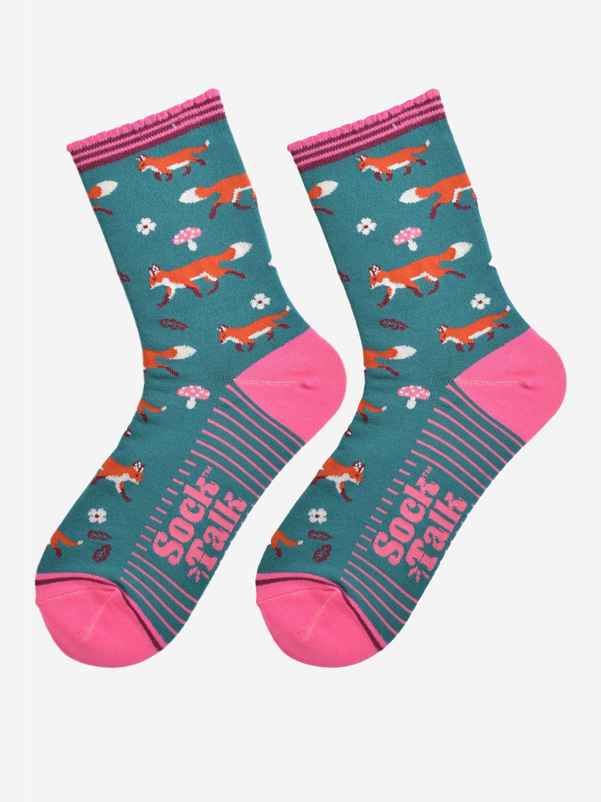 red fox woodland socks laying flat, showing the all over fox, leaf and toad stool pattern and pink accents