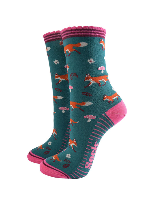 green socks with pink accents and an all over pattern featuring red foxes and toadstools