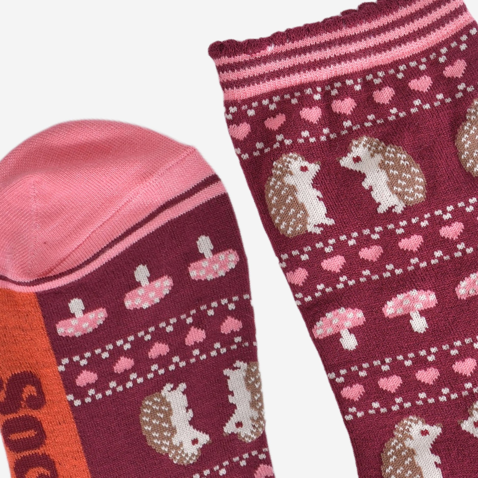 close up of the toe and cuff, the toe is pink and the cuffs are scalloped with pink and burgundy stripes in keeping with the colours of the sock