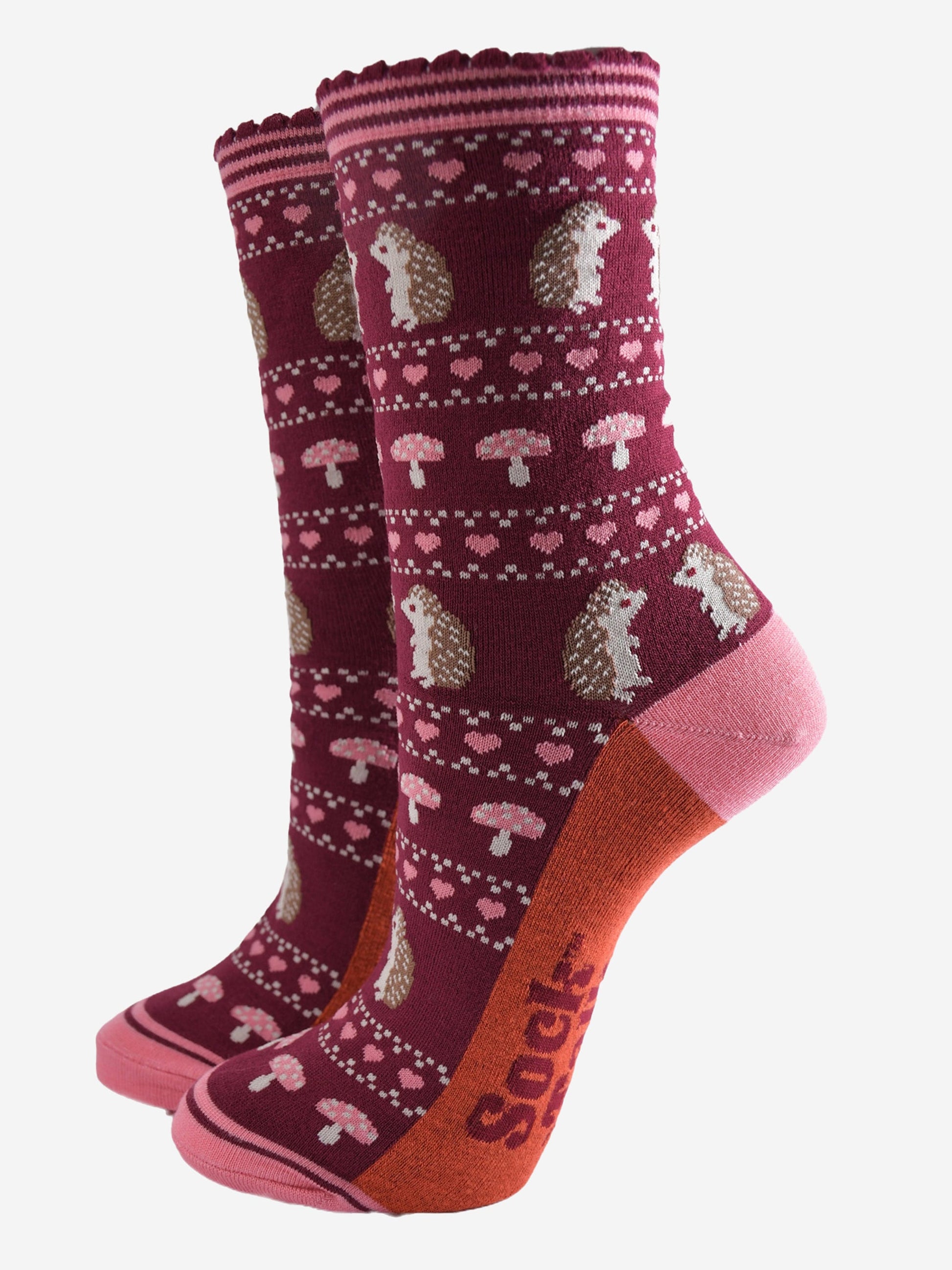 berry red bamboo socks with a pink striped cuff and an fair isle style pattern featuring hedgehogs, toadstools and pink love hearts