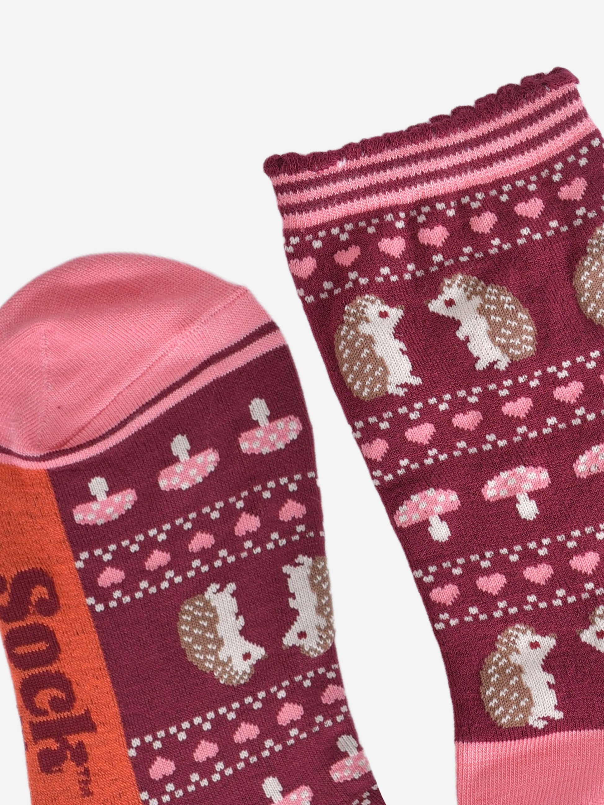 close up of the toe and cuff, the toe is pink and the cuffs are scalloped with pink and burgundy stripes in keeping with the colours of the sock