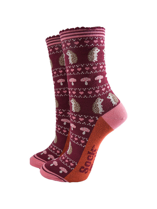 berry red bamboo socks with a pink striped cuff and an fair isle style pattern featuring hedgehogs, toadstools and pink love hearts