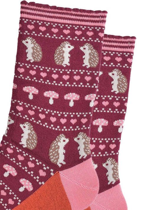 close up of the fair isle style design, showing hedgehogs, toadstools and love hearts in defined rows