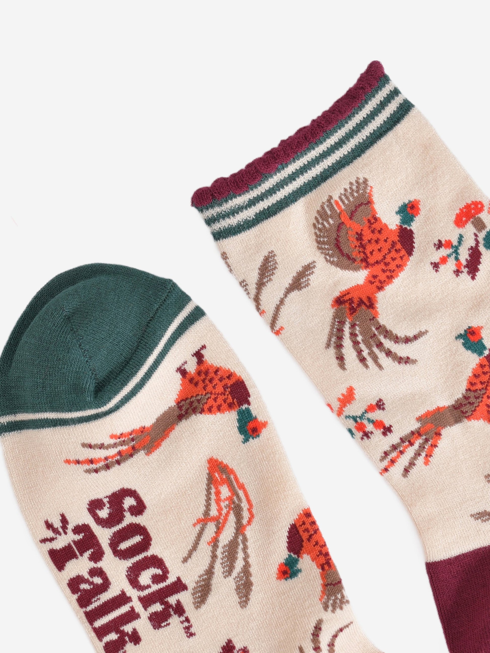 close up of the toe and cuff, the toe is green and the cuff is scalloped with burgundy and green stripes