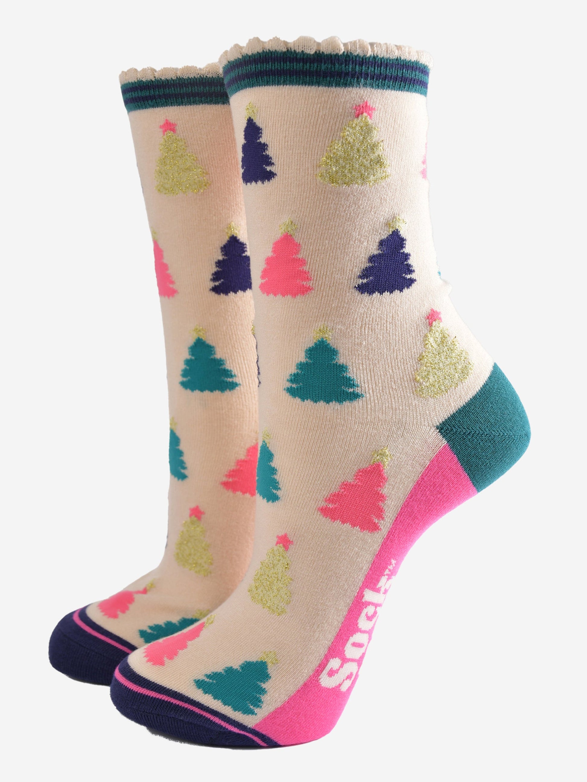 cream bamboo socks with a multicoloured christmas tree pattern all over, the trees are pink, gold, green and navy blue